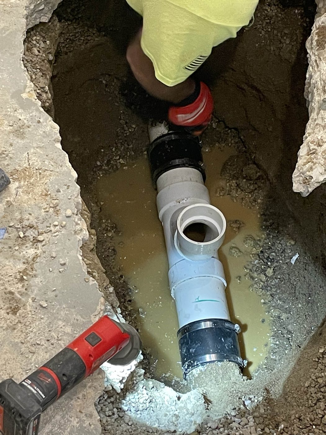 New PVC sewer line and fittings in an open trench — DE Plumbing, Cincinnati