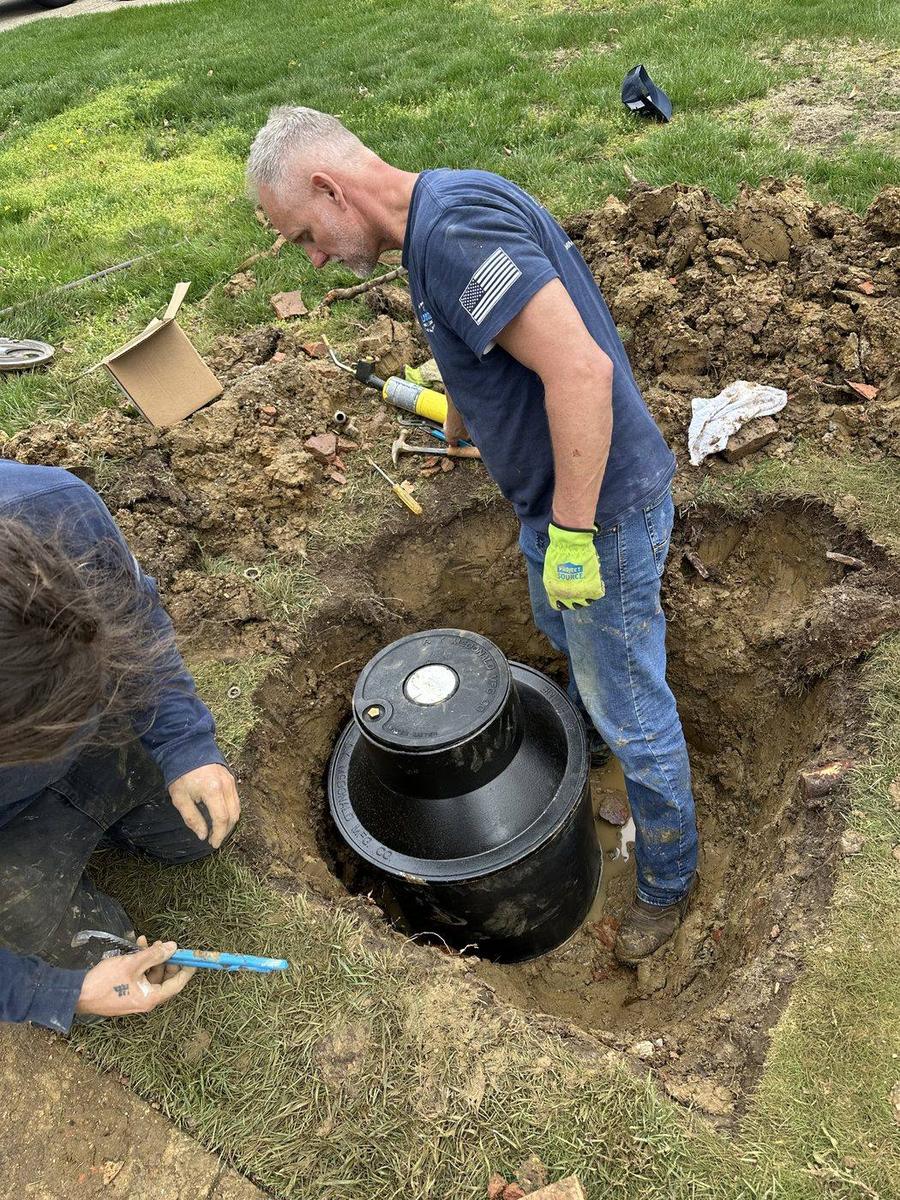 DE Plumbing technician setting a sewer cleanout — DE Plumbing, Cincinnati